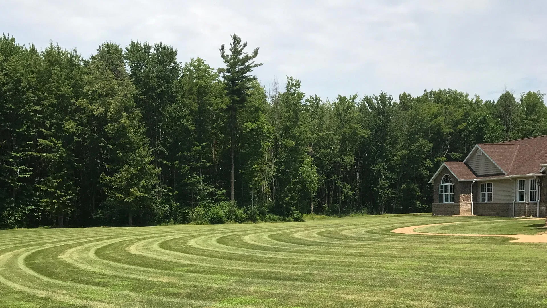 Professionally mowed lawn with stripes at a large property in Ashtabula, OH.