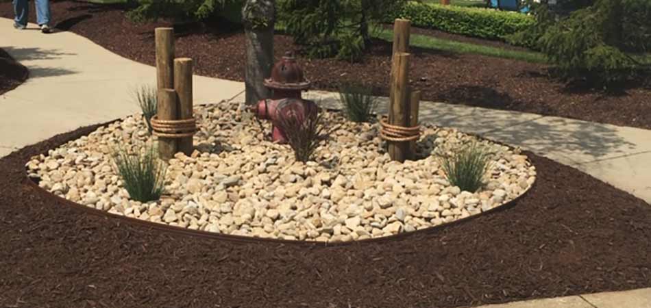 Landscape bed our team installed in Geneva that features both mulch and rock.